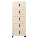armoire pliante tiroirs beige moderne rayures diagonales poignées dorées roulettes sans