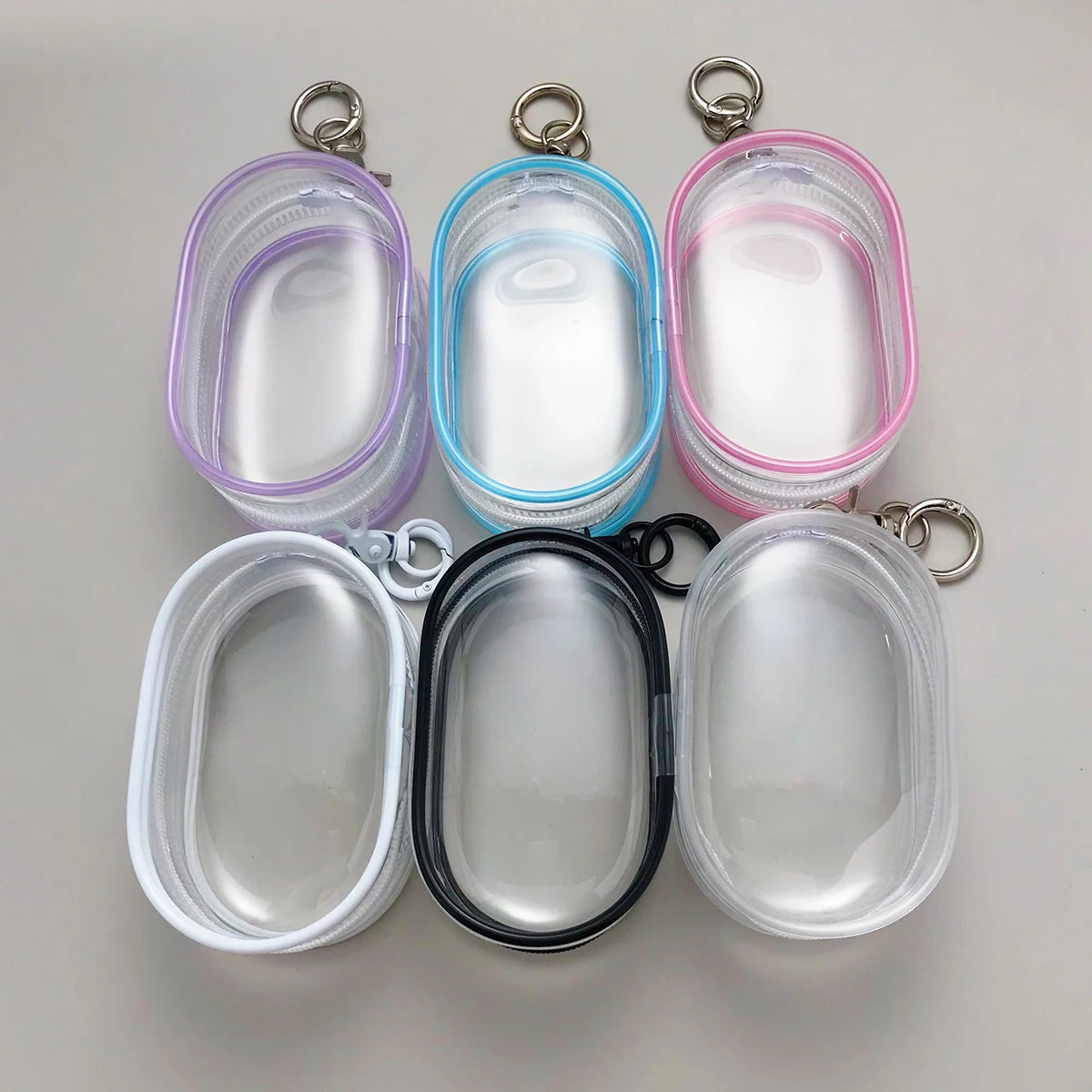 coque protection transparente moderne minimaliste anneaux métalliques boucles portes clés écouteurs sans fil rose