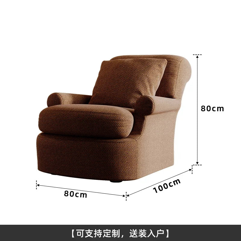 fauteuil confortable moderne marron tissu texturé coussin assorti salon chaleureux cosy minimaliste