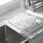 plateau rangement blanc moderne grille perforations tasse thé théière fruits tapis sol écologique