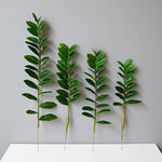 plantes artificielles branches vertes feuilles simples extérieur moderne pot blanc exposé