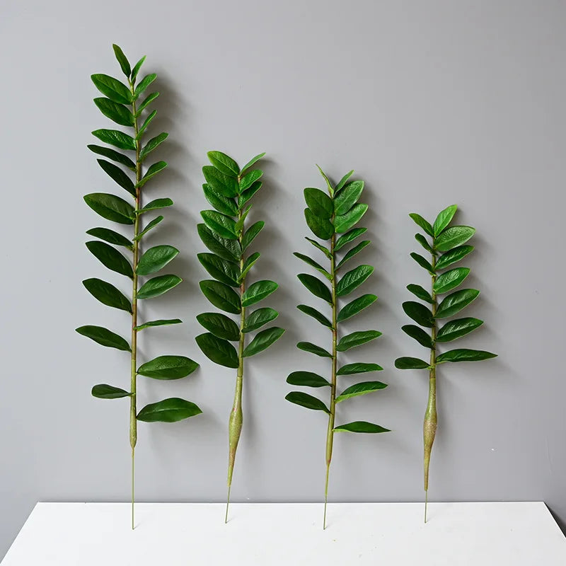 plantes artificielles branches vertes feuilles simples extérieur moderne pot blanc exposé
