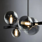 suspension lumineuse moderne noir doré verre transparent anneaux lumineux globes contemporains
