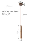 Lampe suspendue moderne minimaliste pierre beige clair texture granulée câble noir pendentif chambre salon