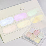 peintures aquarelle palette compacte bleu vert violet rose beige jaune blanc texture granuleuse opaques