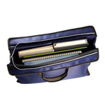 sac main moderne bleu géométrique poignées métalliques carnet stylo papier ruban