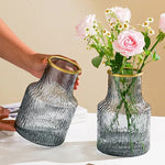 Vase hydroponique en verre avec plantes vertes dans un bureau contemporain