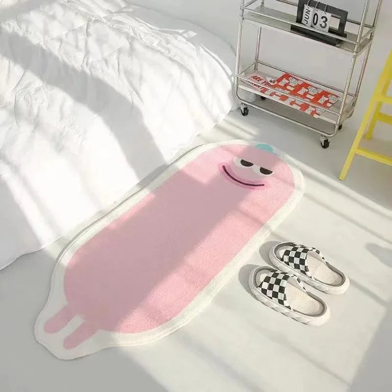 Un coussin rose en forme de personnage avec un sourire représenté sur un lit blanc, à côté de chaussures à carreaux et d'un chariot métallique.