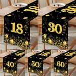 Chemin de table anniversaire noir et or sur table blanche