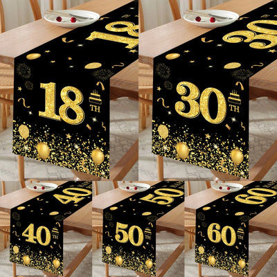 Chemin de table anniversaire noir et or sur table blanche