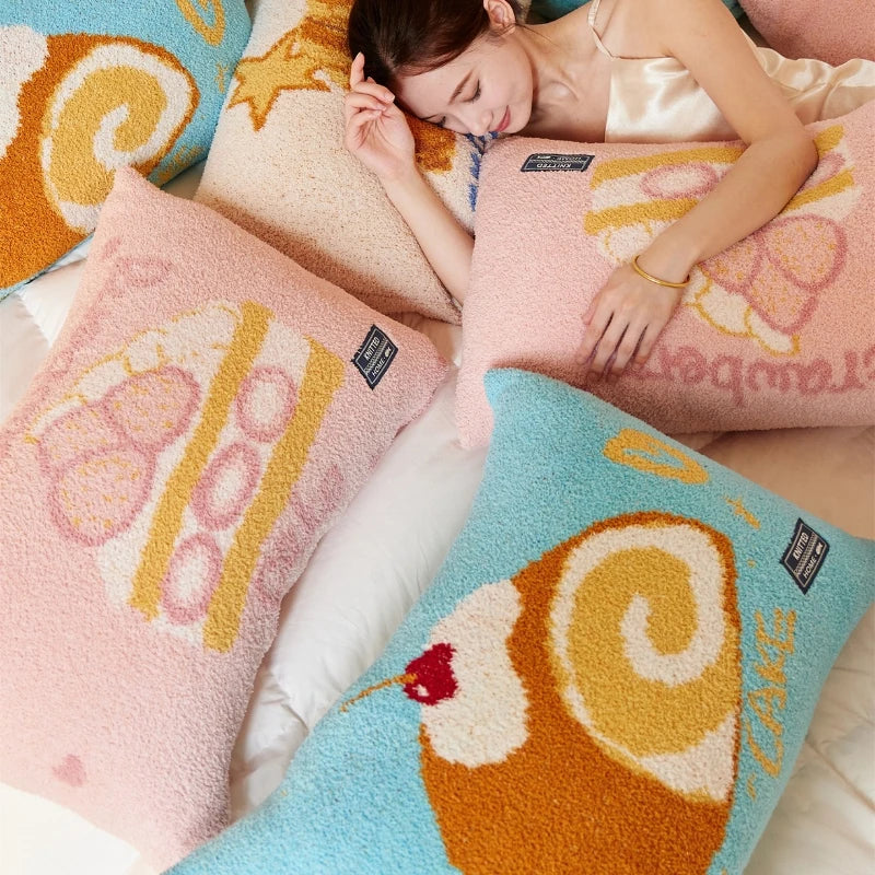 Une personne dort paisiblement sur des oreillers et couvertures de couleurs vives et motifs amusants.