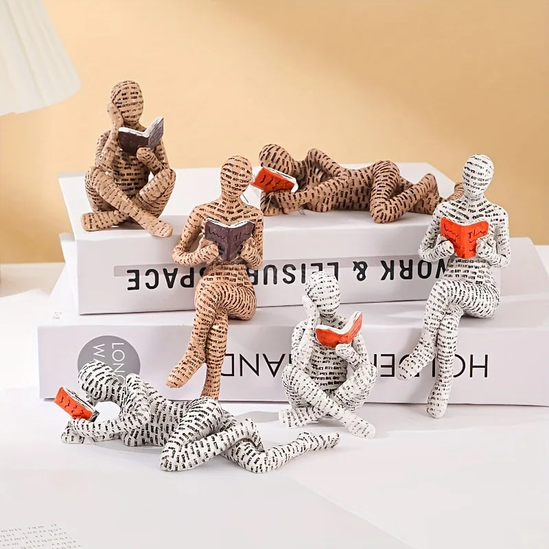 figurines decoratives modernes personnages lisant livres piles livres beige blanc orange minimaliste