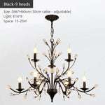 chandelier noir moderne cristaux transparents ampoules blanc chaud suspension élégante branches floralesstylisées