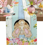 Une table de pâques joliment décorée avec des motifs floraux printaniers et un mignon animal de compagnie.