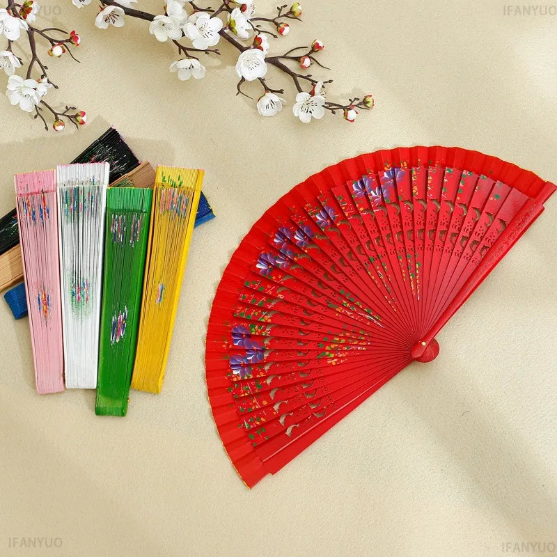 éventail pliant fleurs colorées bois multicolore traditionnel perforations rouge vert bleu élégant