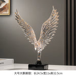 statuette animale moderne transparente dorée oiseau cerfs ailes déployées base noire