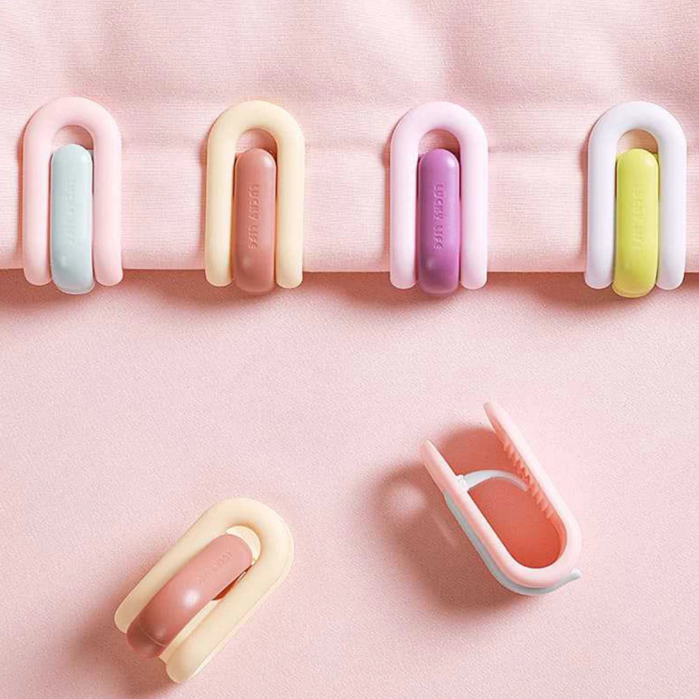 clips rangement moderne rose clair beige vert pastel violet adhésifs minimalistes pièces invisible housse