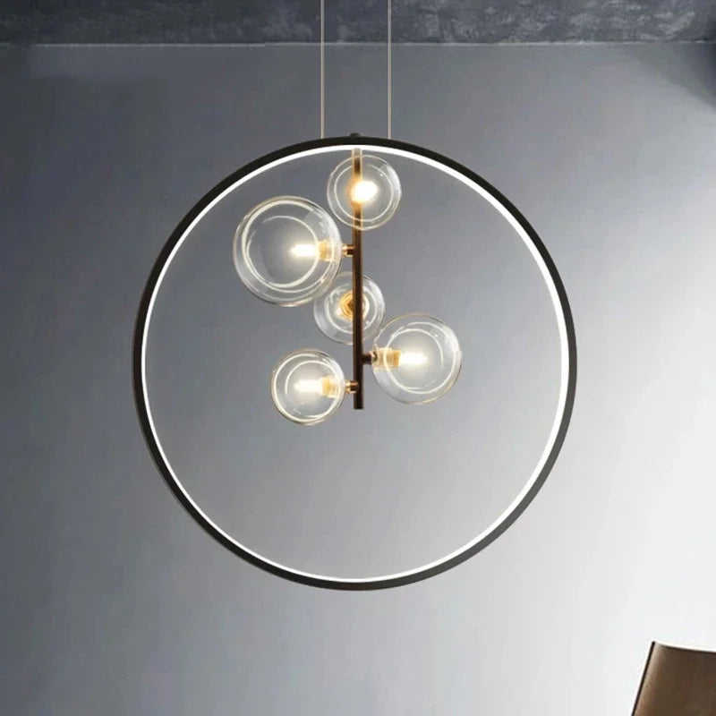 lumière suspendue moderne pendentif géométrique transparent cercles métalliques dorés chambre salon