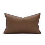 Un coussin rectangulaire brun avec un motif géométrique décoratif.