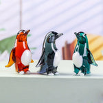 statuettes manchots transparents artisanales couleur verte orangée noire