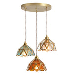 suspension lumineuse verre teinté art deco or marron bleu clair motifs géométriques opacité chaînes
