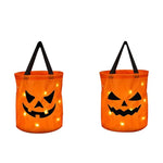 sac lumineux citrouille halloween orange noir motif yeux triangles LED enfants festif