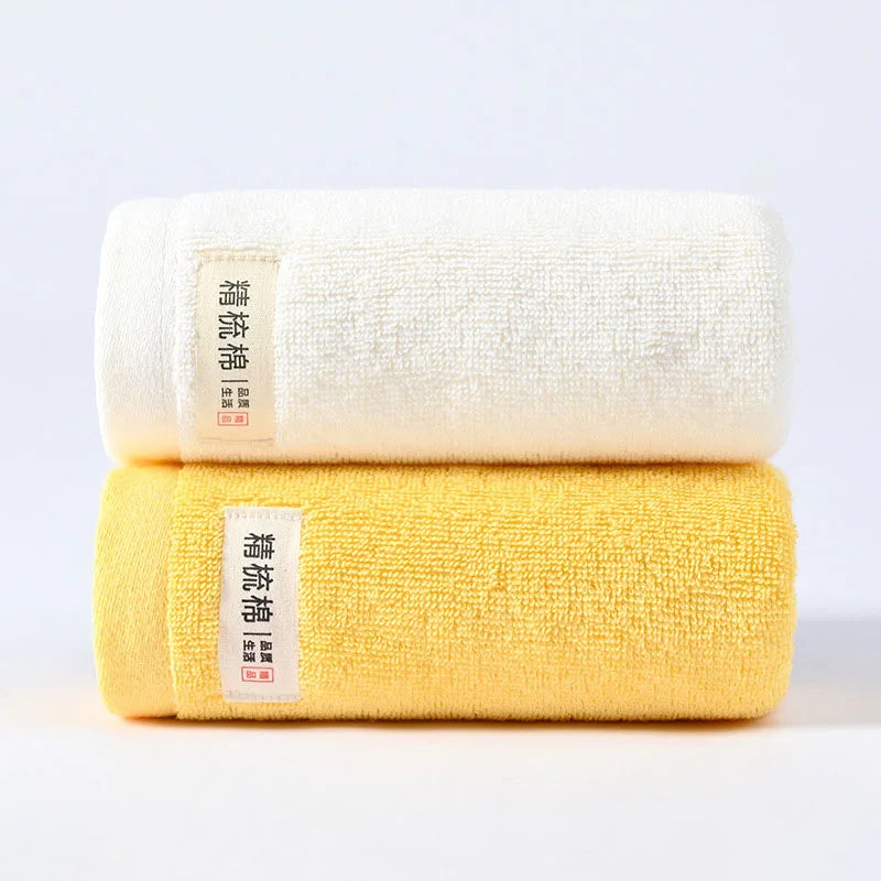 serviettes bain coton douces absorber vert clair jaune gris orange blanc texture duveteuse moderne