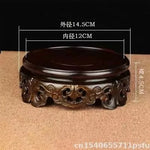 support circulaire bois sculpté artisanal traditionnel marron foncé détails complexes vase plantes décoration maison
