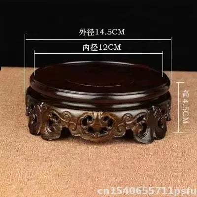 support circulaire bois sculpté artisanal traditionnel marron foncé détails complexes vase plantes décoration maison