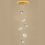 suspension lumineuse moderne transparente dorée facettes géométriques élégantes multiples lampes