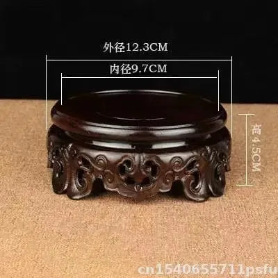 support circulaire bois sculpté artisanal traditionnel marron foncé détails complexes vase plantes décoration maison