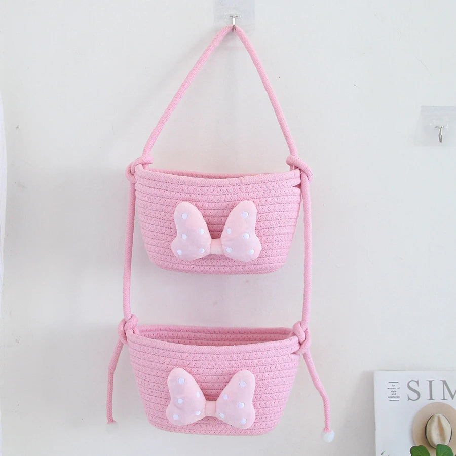panier rangement rose blanc rayures horizontales noeud décoratif réutilisable polyestère enfantin cordelette organisation jouets