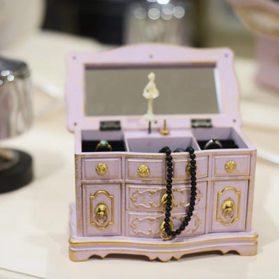 Boîte à bijoux musicale vintage gris foncé sur commode