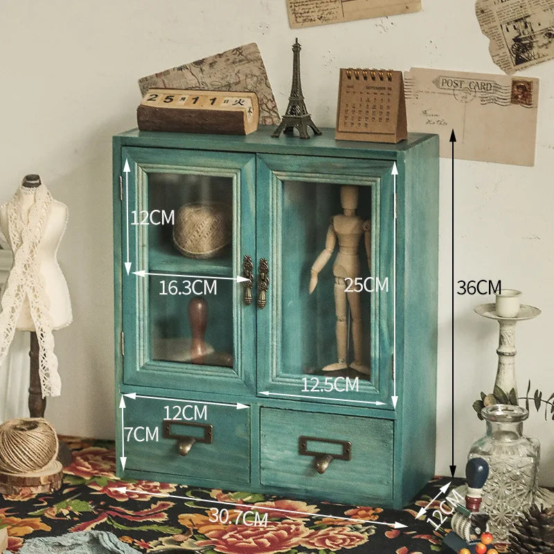 armoire vintage deux portes vitrées deux tiroirs bois marron clair verres transparents objets rangement
