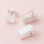 clips plastique transparent rose adhésifs muraux suspendus boîte compartiments protracteur règle feuilles