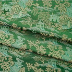 tissu brocart vert foncé motifs asiatiques semi transparent traditionnel décoration artisanale fleurs livre