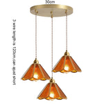 suspension lumineuse verre teinté art deco or marron bleu clair motifs géométriques opacité chaînes