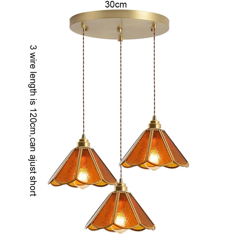 suspension lumineuse verre teinté art deco or marron bleu clair motifs géométriques opacité chaînes