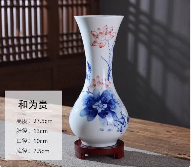 Vase de style oriental décoré de fleurs bleues et roses sur fond blanc.