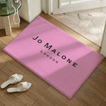 tapis moderne logo jo malone londres beige clair noir bordure diagonale résistant décoloration polyester