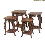 table basse bois rose classique gravures artisanal marron clair pot plante figurine cadre photo