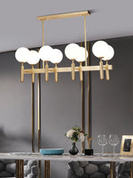 suspension lumineuse moderne or noir sphères translucides métal poli élégante led chambre salon