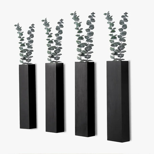 Jardinière murale noire en bois avec plantes vertes dans un salon moderne