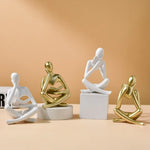 figurine deco moderne or noir blanc personne assise livre socle chambre abstraction minimalisme