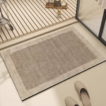 Un tapis gris clair et texturé, reposant sur un sol en bois clair, crée une ambiance relaxante et épurée dans cette pièce moderne et élégante.