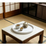 plateau rond blanc surface texturée moderne rangement cosmétiques épices bougies parfumées théière fruits gâteaux
