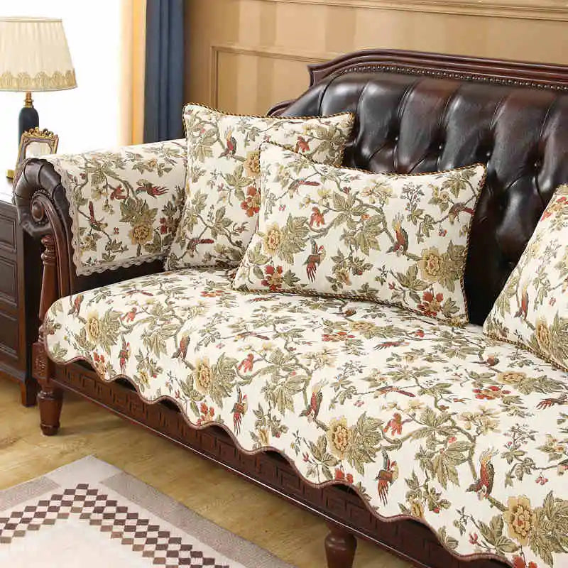 Canapé en cuir brun et tissus à motifs floraux colorés, créant une ambiance élégante et chaleureuse dans cette pièce.