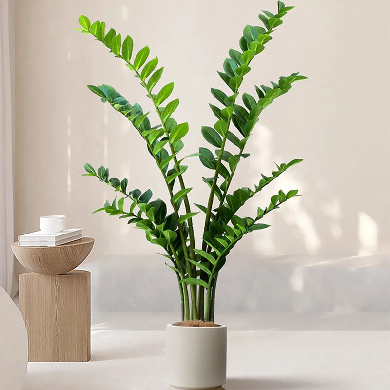 plantes artificielles branches vertes feuilles simples extérieur moderne pot blanc exposé