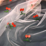 tissu polyester brodé fruits rouges verts transparent broderie blanc roseclair
