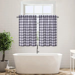 Rideaux courts à motifs vichy noirs et blancs, installés sur une fenêtre de salle de bain au-dessus d’une baignoire.